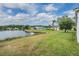 Expansive backyard with direct access to a serene lake, perfect for outdoor relaxation at 1053 Winding Willow Dr, Trinity, FL 34655