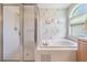 Bathroom showcasing a soaking tub, walk-in shower, and natural light from a window at 1053 Winding Willow Dr, Trinity, FL 34655