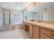 Bathroom featuring a double sink vanity, a soaking tub, and a walk-in shower at 1053 Winding Willow Dr, Trinity, FL 34655