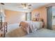 Cozy bedroom with large windows, neutral colors, and a ceiling fan at 1053 Winding Willow Dr, Trinity, FL 34655