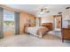 Comfortable bedroom with large windows, neutral colors, and a ceiling fan at 1053 Winding Willow Dr, Trinity, FL 34655