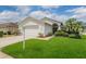 Charming single-story home with a well-manicured lawn and a beautifully landscaped front yard at 1053 Winding Willow Dr, Trinity, FL 34655