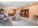 Spacious living room with neutral carpeting, a large entertainment center, and views into the dining room at 1053 Winding Willow Dr, Trinity, FL 34655