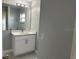Bathroom features white sink cabinet with white countertop, large mirror, recessed lights, gray walls, and marble floors at 10906 Carnelian Ln, Riverview, FL 33578