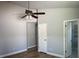 Bedroom with wood-look floors, neutral paint, ceiling fan, closet, and an ensuite bathroom at 10906 Carnelian Ln, Riverview, FL 33578
