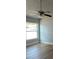 Bedroom features a window for natural light, wood-look floors and a ceiling fan to keep you cool at 10906 Carnelian Ln, Riverview, FL 33578