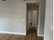 Hallway features light wood-look floors, gray walls, and white trim at 10906 Carnelian Ln, Riverview, FL 33578