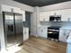 Modern kitchen featuring stainless steel appliances, white cabinets, and a light grey wall at 10906 Carnelian Ln, Riverview, FL 33578