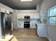 Modern kitchen featuring stainless steel appliances, white cabinets, and hardwood floors at 10906 Carnelian Ln, Riverview, FL 33578