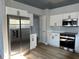 Modern kitchen featuring stainless steel appliances, white cabinets, and hardwood floors at 10906 Carnelian Ln, Riverview, FL 33578