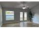 Well lit living room featuring hardwood floors, ceiling fan and access to the yard at 10906 Carnelian Ln, Riverview, FL 33578