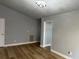 Open-concept living room with hardwood flooring, neutral paint, and modern lighting at 10906 Carnelian Ln, Riverview, FL 33578