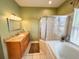 Bright bathroom with granite counters, a tiled floor, and a glass-enclosed shower at 1121 Riveredge Dr, Tarpon Springs, FL 34689