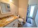 Bathroom with a granite countertop vanity, toilet, and walk-in shower at 1121 Riveredge Dr, Tarpon Springs, FL 34689