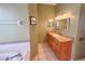 Bathroom with a granite countertop vanity, white tile floors, and a view of the bathtub at 1121 Riveredge Dr, Tarpon Springs, FL 34689