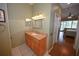 Bathroom with a granite countertop vanity and a view of the bedroom with a pool view at 1121 Riveredge Dr, Tarpon Springs, FL 34689