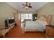 Well-lit bedroom with hardwood floors and a sliding glass door to the pool area at 1121 Riveredge Dr, Tarpon Springs, FL 34689
