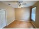 Empty bedroom with a ceiling fan, wood floor, and a closet at 1121 Riveredge Dr, Tarpon Springs, FL 34689