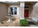 Elegant front entrance with a fountain, white trim, and a vibrant red double door at 1121 Riveredge Dr, Tarpon Springs, FL 34689