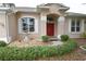 Inviting home entrance featuring a decorative fountain, white shutters, and a vibrant red door at 1121 Riveredge Dr, Tarpon Springs, FL 34689