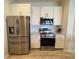 Modern kitchen features stainless steel appliances, granite countertops, and white cabinets at 1121 Riveredge Dr, Tarpon Springs, FL 34689