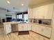 Bright, open kitchen with white cabinets, granite countertops, and stainless steel appliances at 1121 Riveredge Dr, Tarpon Springs, FL 34689