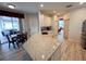 Kitchen featuring granite countertops, white cabinetry, and wood-look floors at 1121 Riveredge Dr, Tarpon Springs, FL 34689