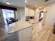 Kitchen featuring granite countertops, white cabinetry, and wood-look floors at 1121 Riveredge Dr, Tarpon Springs, FL 34689