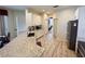 Kitchen featuring granite countertops, white cabinetry, and wood-look floors at 1121 Riveredge Dr, Tarpon Springs, FL 34689