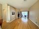 Spacious living room with hardwood floors leading to a screened-in patio and pool at 1121 Riveredge Dr, Tarpon Springs, FL 34689