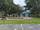 Community playground featuring a slide and a shaded gazebo for relaxation and play at 1121 Riveredge Dr, Tarpon Springs, FL 34689