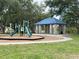 Community playground featuring a slide and a shaded gazebo for relaxation and play at 1121 Riveredge Dr, Tarpon Springs, FL 34689