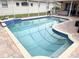 Private screened-in pool with blue tile accents and brick patio area, perfect for outdoor entertaining at 1121 Riveredge Dr, Tarpon Springs, FL 34689