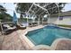 Outdoor pool with lake view, comfortable lounge seating, and a hot tub at 1121 Riveredge Dr, Tarpon Springs, FL 34689