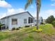 A lovely backyard showing a well-maintained lawn, a screen enclosed patio, and attractive landscaping at 11342 Hollander Ave, Hudson, FL 34667