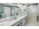 Clean bathroom featuring a tiled shower, vanity with storage, and contemporary decor with coastal accents at 11342 Hollander Ave, Hudson, FL 34667
