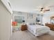 Comfortable bedroom with a ceiling fan, two windows and plush carpeting and neutral decor at 11342 Hollander Ave, Hudson, FL 34667