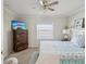Relaxing bedroom with ceiling fan, dresser with TV, and comfortable furnishings at 11342 Hollander Ave, Hudson, FL 34667