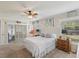 Cozy bedroom features a ceiling fan, sliding glass doors, and plush carpet flooring at 11342 Hollander Ave, Hudson, FL 34667