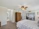 Spacious bedroom with sliding glass doors to sunroom, walk in closet, ceiling fan, carpet flooring and ensuite bathroom at 11342 Hollander Ave, Hudson, FL 34667