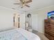 Bright bedroom features a ceiling fan, large closet, and attached bathroom at 11342 Hollander Ave, Hudson, FL 34667