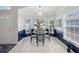 Cozy dining area features tiled floors, large windows with blinds, and elegant decor at 11342 Hollander Ave, Hudson, FL 34667