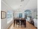 Bright dining area with hardwood floors, pendant lighting, and large windows, adjacent to living area at 11342 Hollander Ave, Hudson, FL 34667