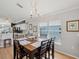 Dining room with hardwood floors, modern chandelier, and views of the kitchen at 11342 Hollander Ave, Hudson, FL 34667