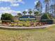 Community entrance sign with lush landscaping and clear signage at 11342 Hollander Ave, Hudson, FL 34667