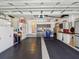 Organized garage space with rubber flooring, storage cabinets, and ample workspace at 11342 Hollander Ave, Hudson, FL 34667