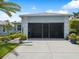 Spacious two-car garage with screen doors and concrete driveway offering ample parking space at 11342 Hollander Ave, Hudson, FL 34667