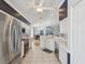 The updated kitchen has stainless steel appliances, white cabinets, and a seamless flow to the dining room at 11342 Hollander Ave, Hudson, FL 34667