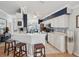 Spacious kitchen features white cabinetry, stainless steel appliances and a breakfast bar with stool seating at 11342 Hollander Ave, Hudson, FL 34667