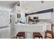 Open-concept kitchen with breakfast bar, stainless steel appliances, and tile floors at 11342 Hollander Ave, Hudson, FL 34667